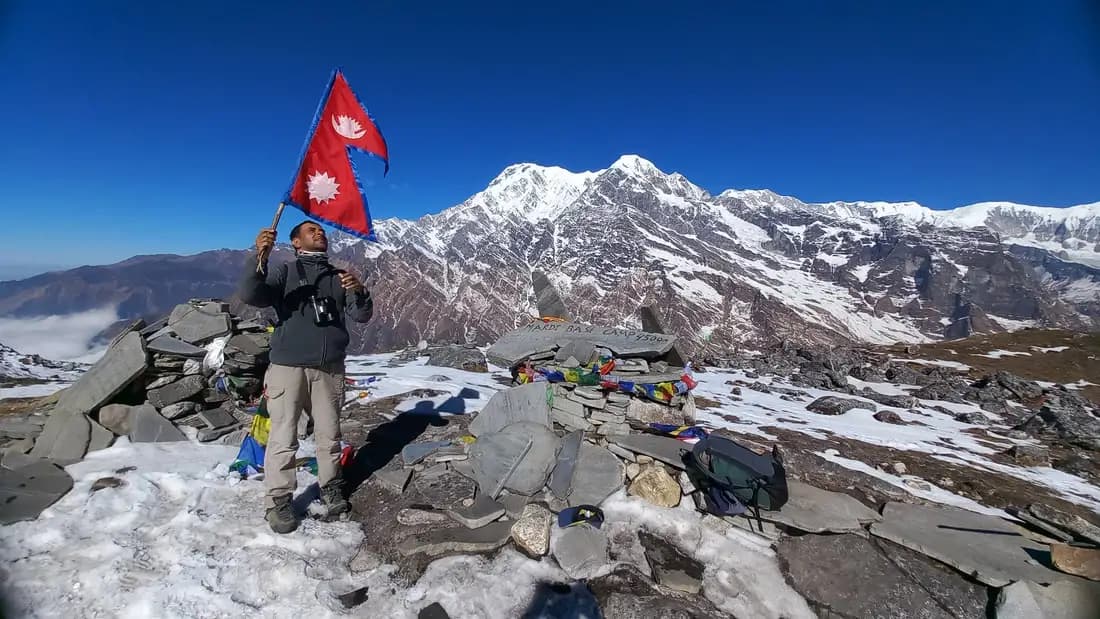 man in Mardi Himal trek with Nepal flag
