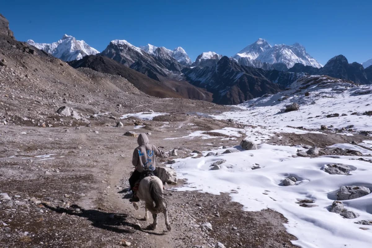 man riding horse on renjo la pass trek